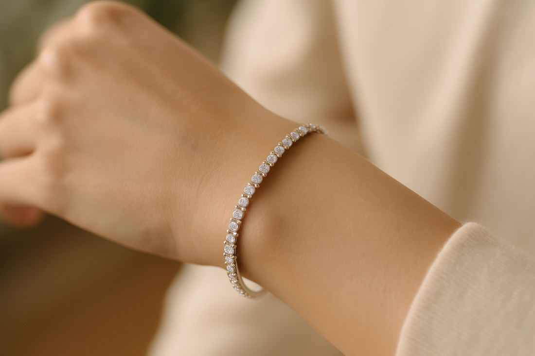 Close-up of a woman’s wrist wearing a diamond tennis bracelet, showcasing timeless elegance and refined sparkle.