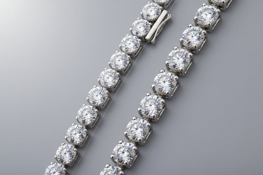 Close-up of a genuine diamond tennis bracelet next to a fake imitation on a neutral background, highlighting differences in sparkle, metal, and craftsmanship.